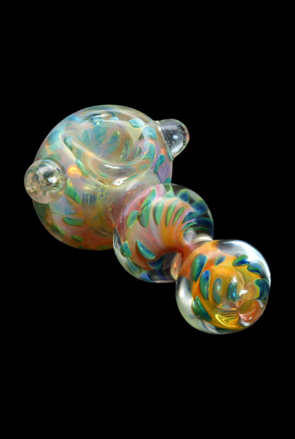 Hand-blown glass pipe with vibrant orange, blue, and green swirls against a black background.
