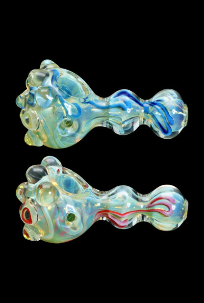 Hand-blown glass pipes with colorful swirls and textured surfaces, displayed against a black background.