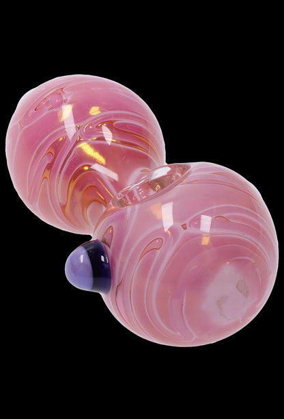 Pink glass bubbler with swirling patterns and a dark blue mouthpiece.
