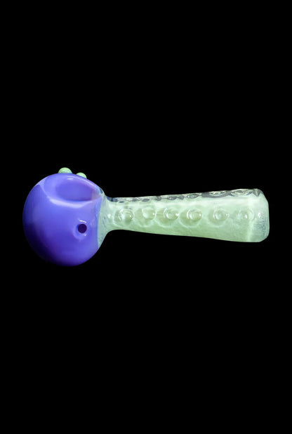 Glass pipe with purple bowl and textured green stem.