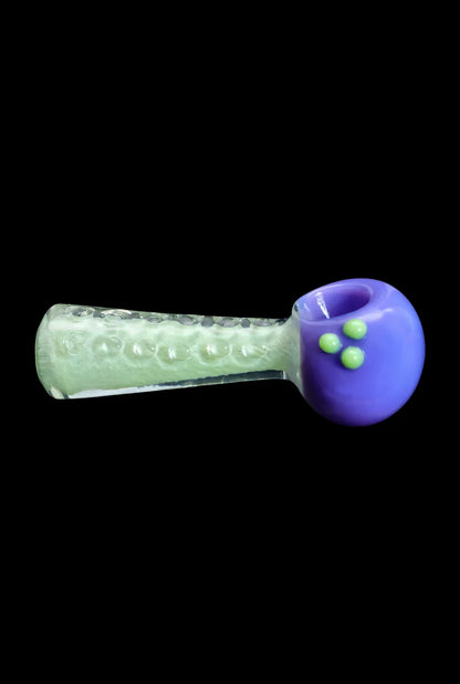 Green and purple glass pipe for smoking cannabis.