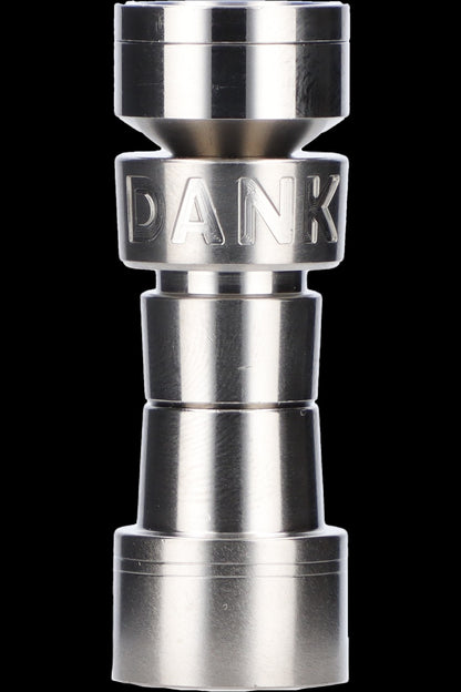 Silver cannabis grinder with “DANK” engraved on the middle tier, against a black background.