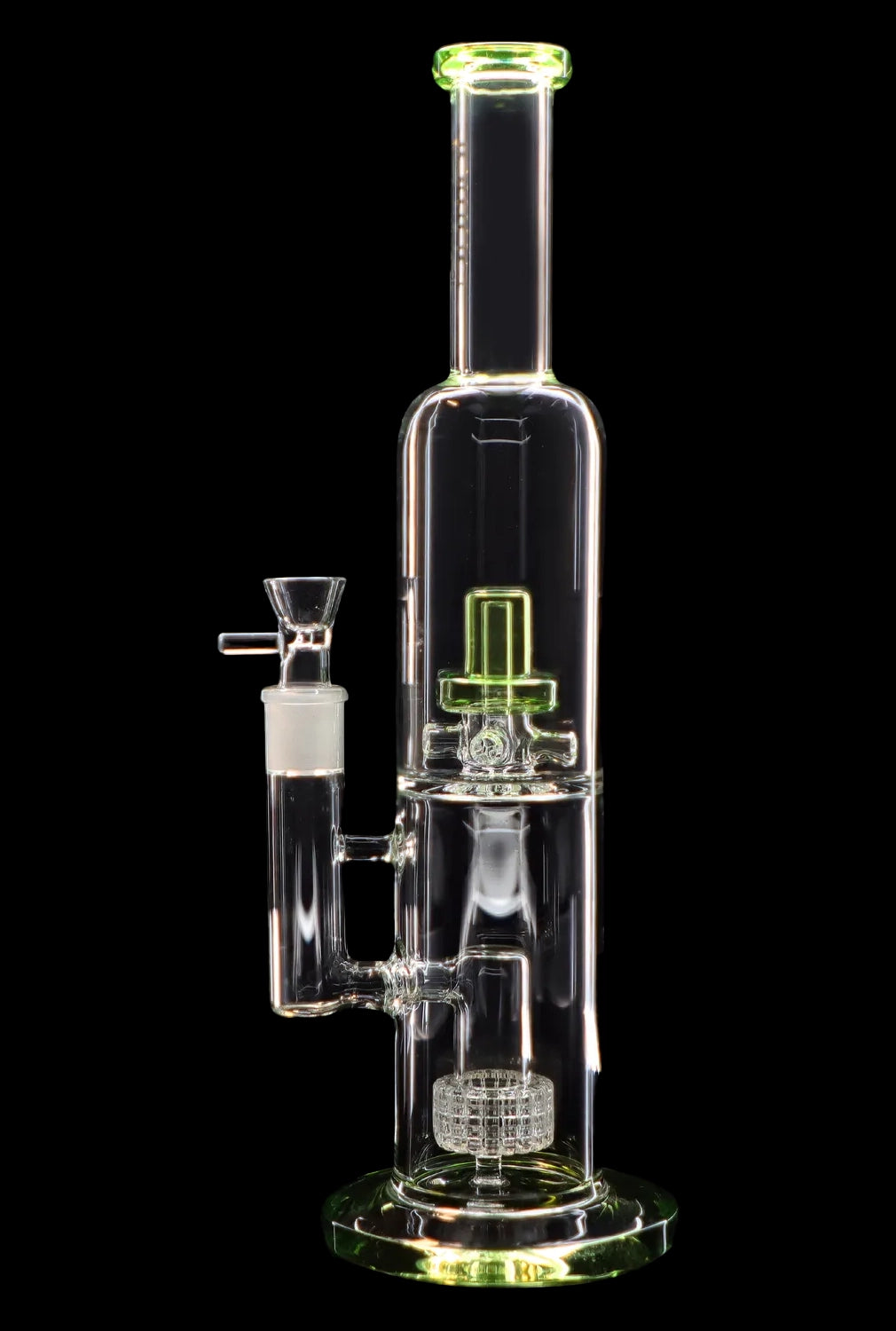 A clear glass water pipe (bong) with green accents and intricate percolators, displayed against a black background.