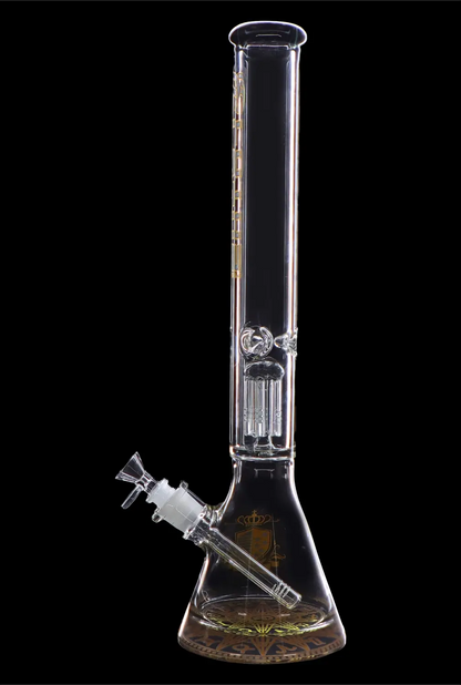 Clear glass bong with intricate percolators and a wide, patterned base, isolated on a black background.