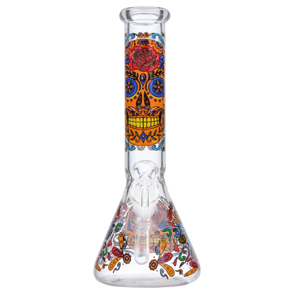 Centered frontal view of the Smoke Cartel Skull Beaker Bong - 10 in. showing a vertical orange sugar-skull motif on the neck and colorful floral patterns on the beaker base.
