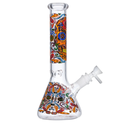 Side view of the Smoke Cartel Skull Beaker Bong - 10 in. showing a clear glass beaker base and straight neck decorated with colorful orange, blue, and red skull-and-floral patterns.