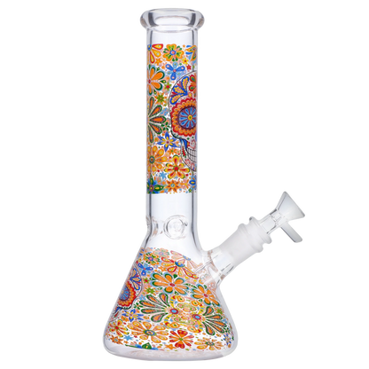 Side view of the Smoke Cartel Skull Beaker Bong - 10 in. showing a clear glass beaker with colorful floral skull decal wrapping the body.