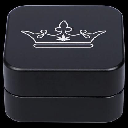 Close-up of the Queen of Bud 2-Piece Grinder, a black metal grinder viewed from a slightly angled, top-down perspective.