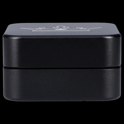 Black cannabis concentrate container with embossed logo.