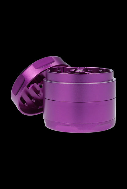 Purple four-piece cannabis grinder with open lid.