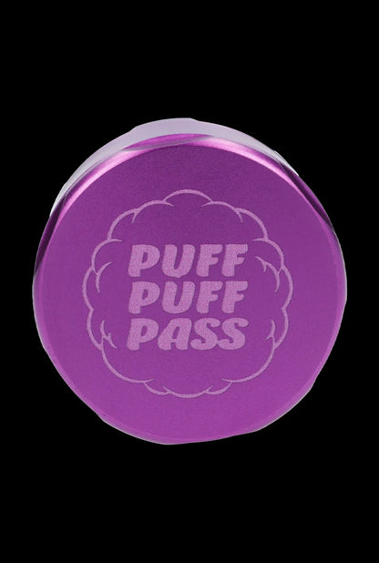 Purple cannabis grinder with “PUFF PUFF PASS” engraved on the lid.