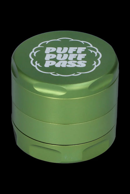 Green metal cannabis grinder with “PUFF PASS” text.