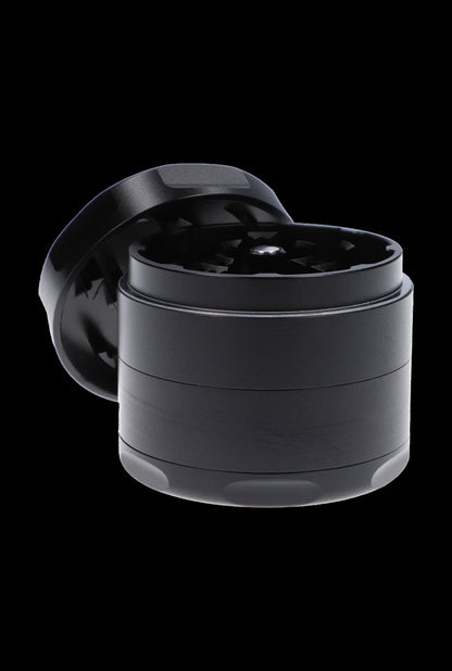 Black four-layer cannabis grinder with open lid.
