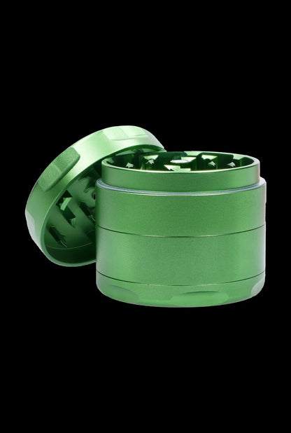 Green four-piece cannabis grinder with open lid.