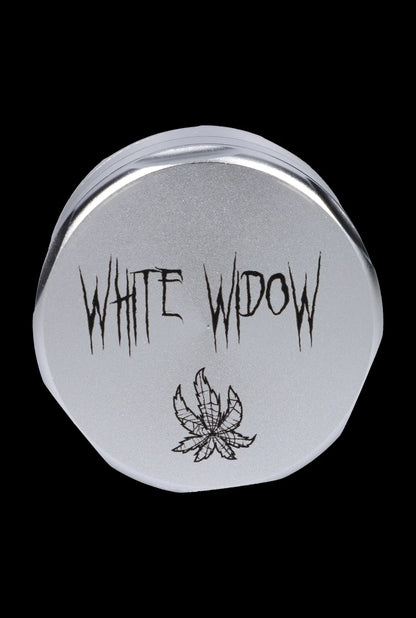 Close-up of a metal tin labeled "White Widow" with a cannabis leaf design.
