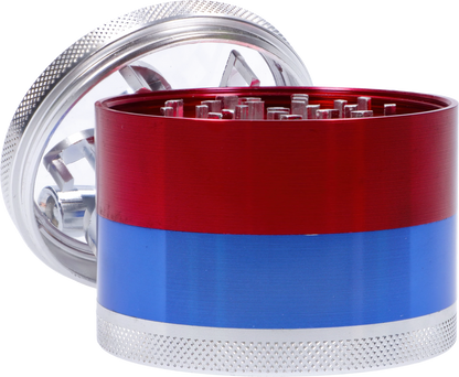 Close-up angled view of a red and blue CNC Aluminum Grinder-Assorted (OEM Colors)-62mm showing metallic teeth and textured silver lid.