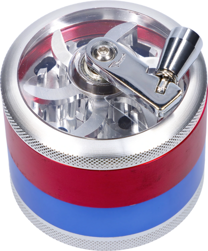 Top-down close-up of a red and blue CNC Aluminum Grinder-Assorted (OEM Colors)-62mm showing its clear lid, visible four-blade teeth, and shiny metal crank.