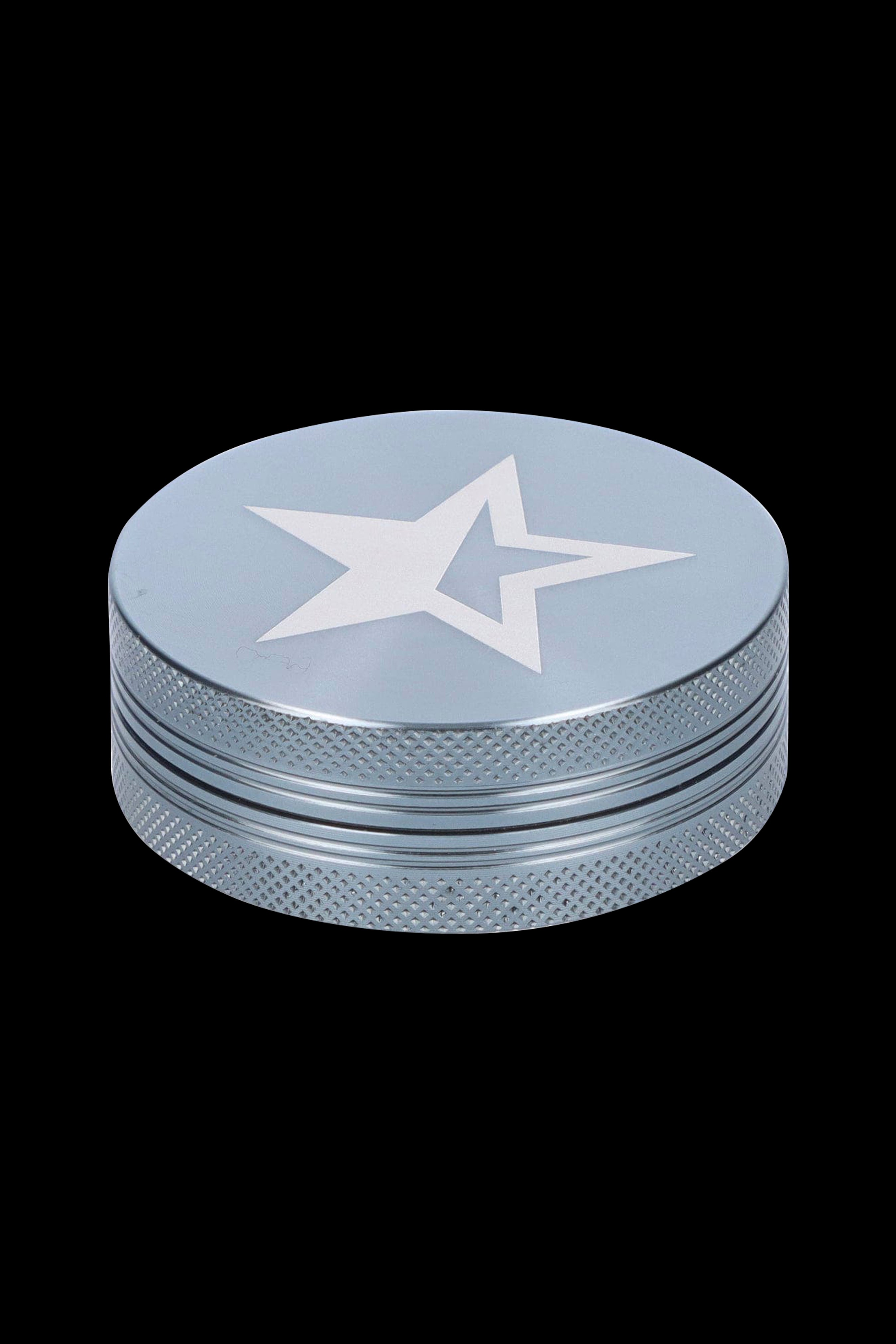Silver cannabis grinder with a white star emblem.