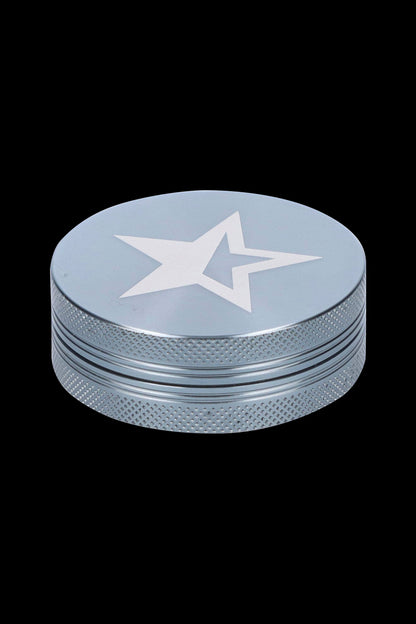 Silver cannabis grinder with a white star emblem.