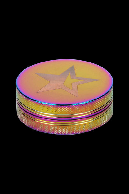 Iridescent cannabis grinder with a star emblem.