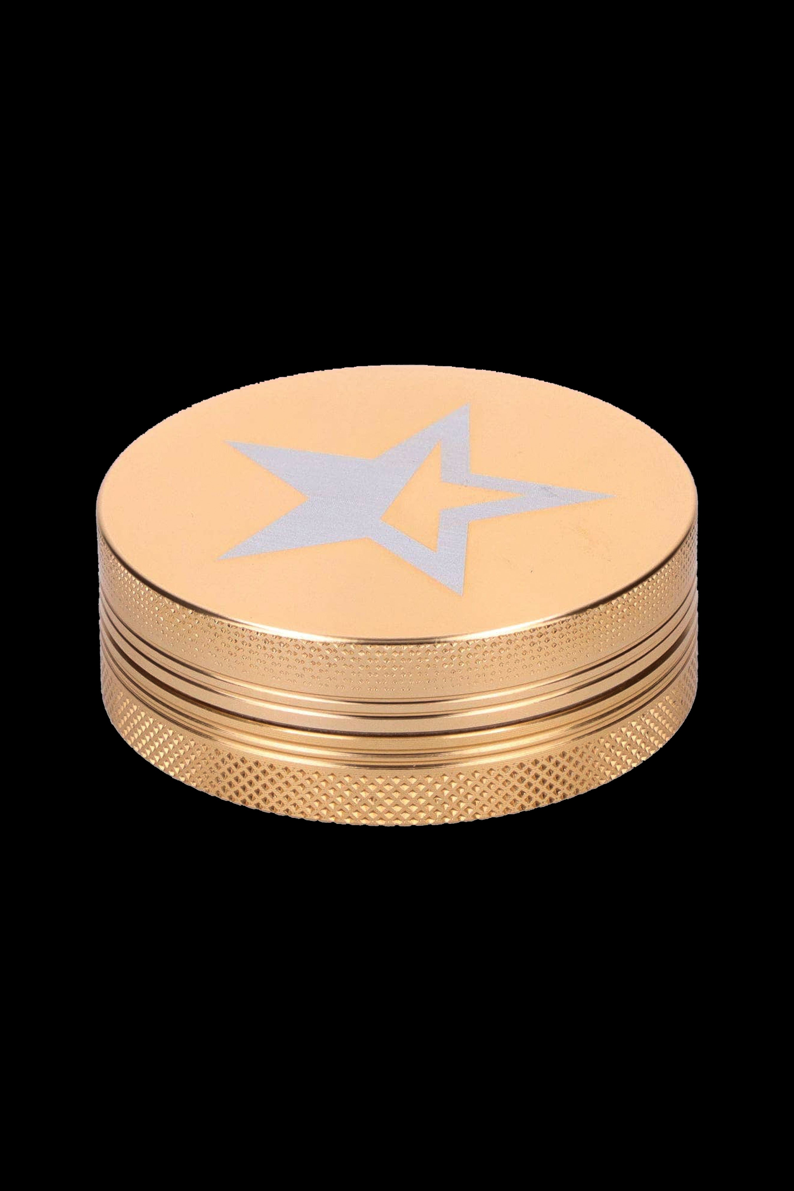 Gold grinder with a star design, used for preparing cannabis.