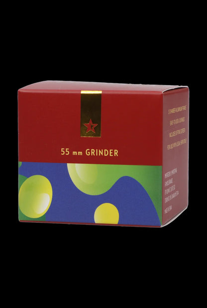 Angled front view of the Famous Design-Privilege Aluminum 3 Stage Grinder-Blue packaging box with red upper panel, colorful blue-green lower artwork, and gold accent.