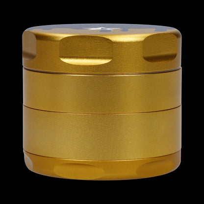 Close-up front view of the gold Famous Design-Surrender Aluminum 3 Stage Grinder-Gold showing its textured stacked chambers and rounded lid against a black background