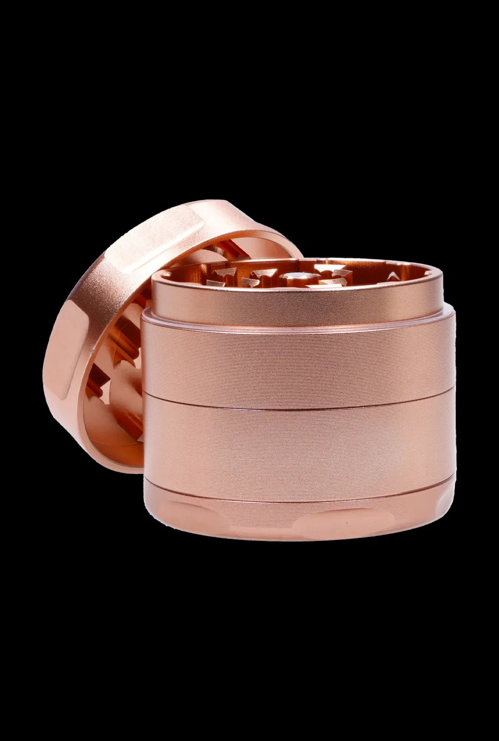 Close-up front view of the Famous Design-Papaya Aluminum 3 Stage Grinder-Rose Gold showing its stacked cylindrical rose gold metal chambers and open top teeth against a black background
