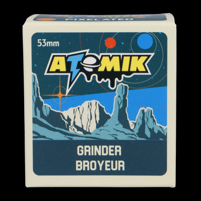 A vintage-style box for a cannabis grinder, labeled “Atomik Grinder” with a retro space mountain design. 