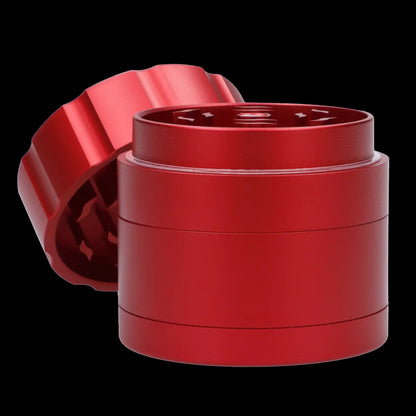 Red four-chamber cannabis grinder with lid partially detached.