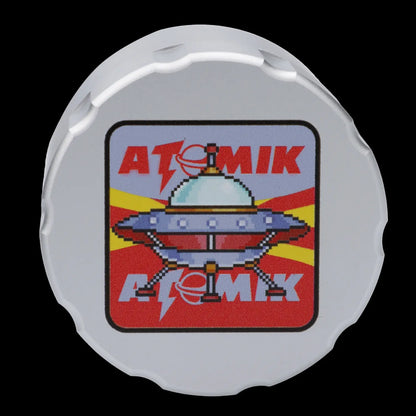 White cannabis accessory lid featuring a pixelated UFO design with "ATOMIK" text.