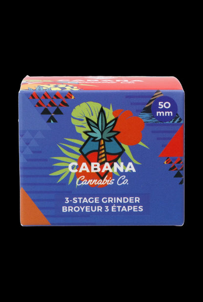 Front-facing shot of the colorful Cabana Cannabis Co. 3-Stage Grinder Parasol Green box with tropical graphics on a black background
