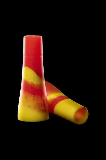 Two colorful silicone tips for dab rigs or similar cannabis accessories against a black background.