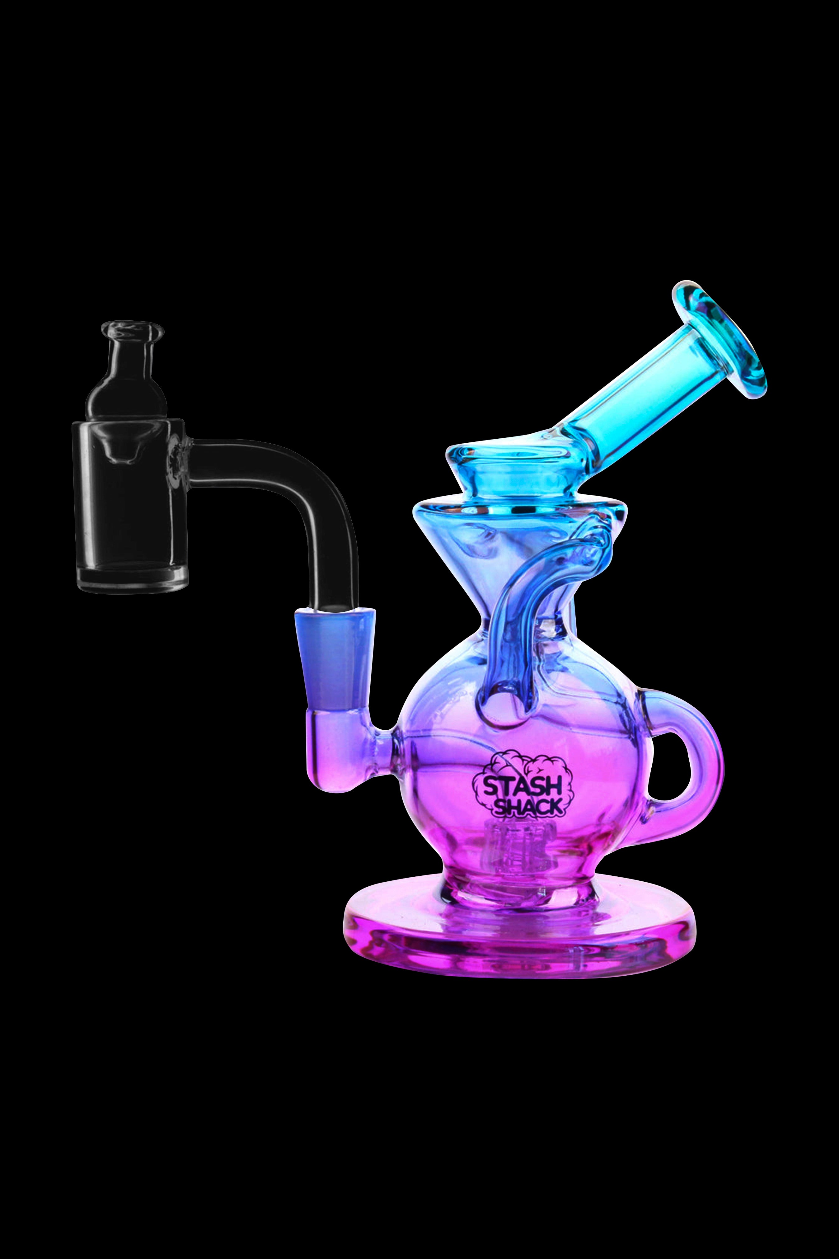 A colorful glass dab rig with a quartz banger, isolated on a black background. 