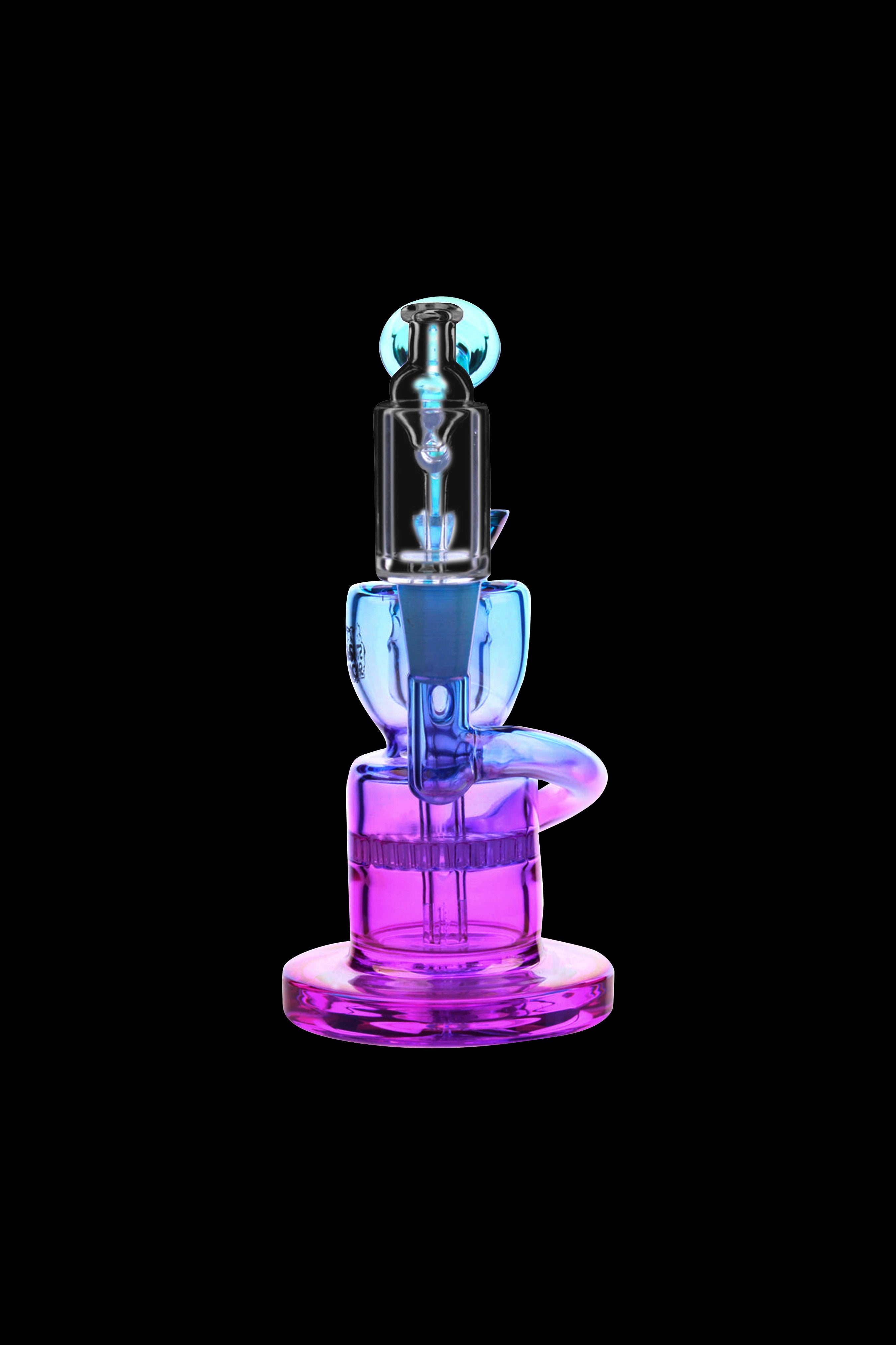 Neon purple and blue glass dab rig isolated on black.