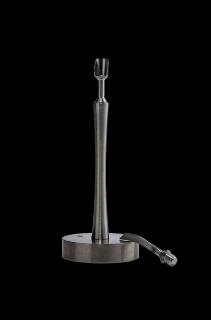 Sleek, metallic dab tool with a circular base, isolated on a black background.