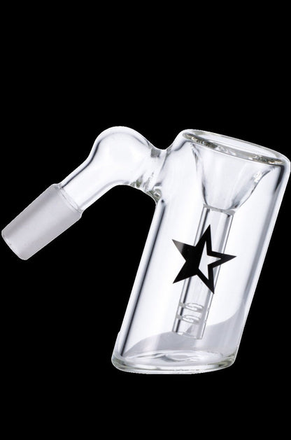 Angled close-up of the Famous X 45 Degree Glass Ash Catcher in clear glass with a black star logo against a solid black background