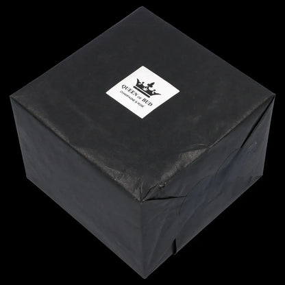 Black gift box with “Queen of Bud” branding, likely containing cannabis accessories. 