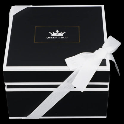 Black gift box with white ribbon and gold "Queen of Bud" logo.