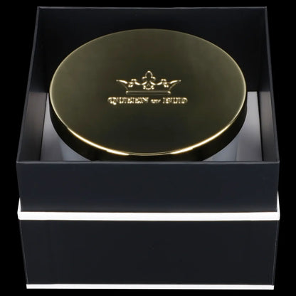 Gold cannabis container presented in a black gift box.