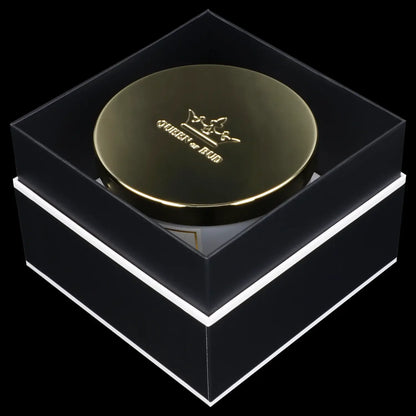Black and gold cannabis storage jar with “Queen of Bud” logo, presented in a matching black box with white trim.