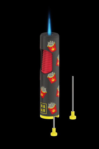 A butane torch lighter with a french fry and cannabis leaf design, accompanied by two dab tool applicators, all against a black background.