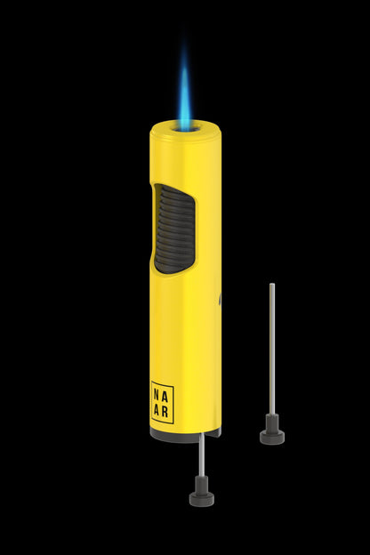 Yellow butane torch lighter with extended nozzle, illuminated blue flame, and “NAR” logo.