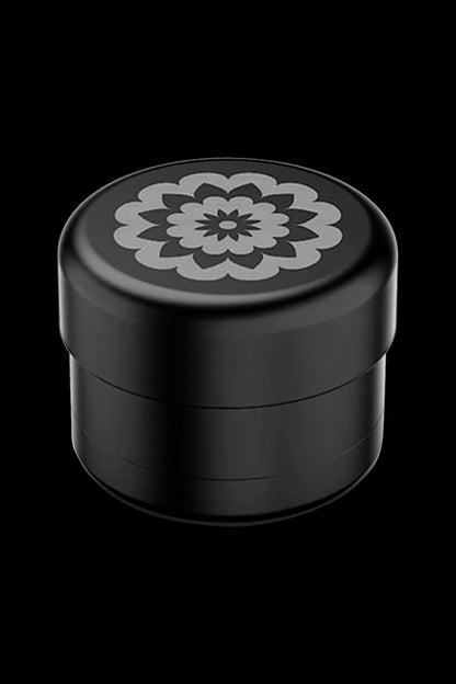 Black cannabis grinder with floral design.