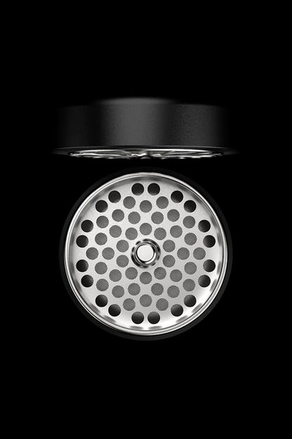 Silver cannabis bowl with perforated pattern against a black background.