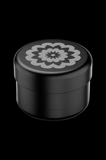 Black four-chamber cannabis grinder with floral design.