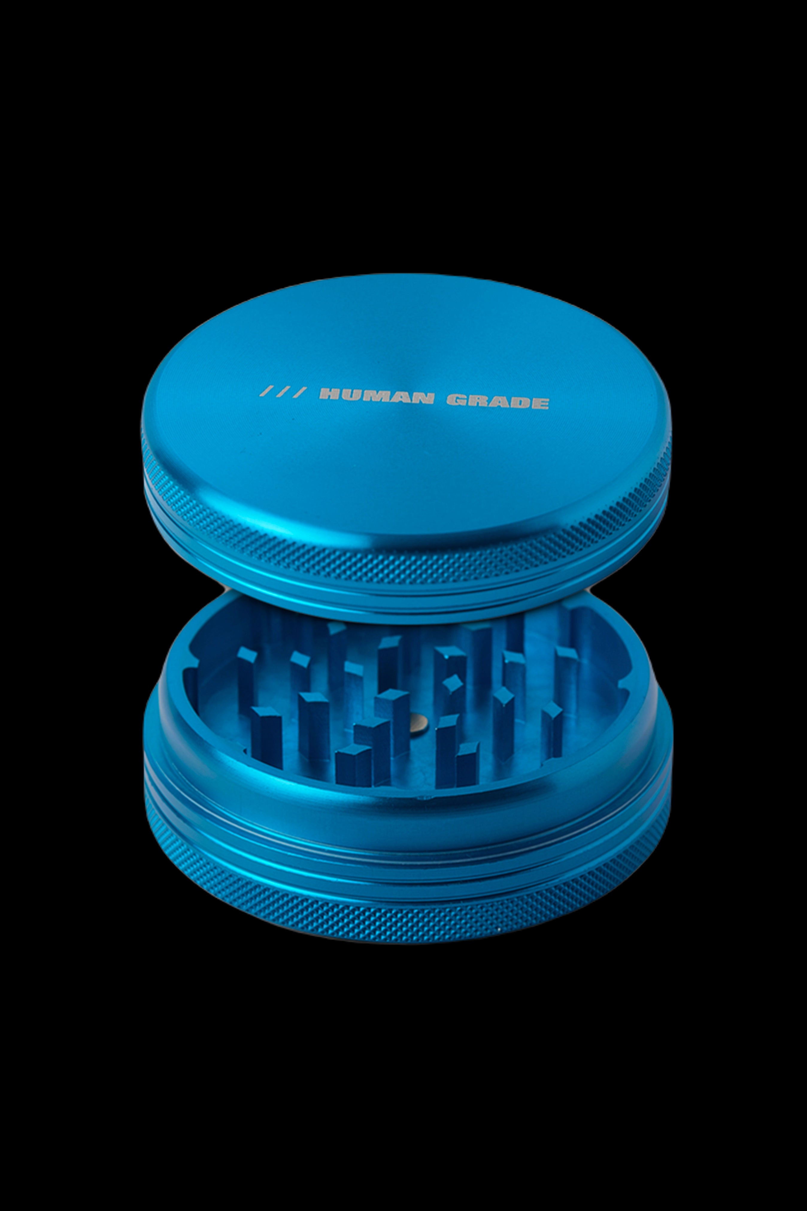 Blue cannabis grinder with visible teeth and text reading "HUMAN GRADE".