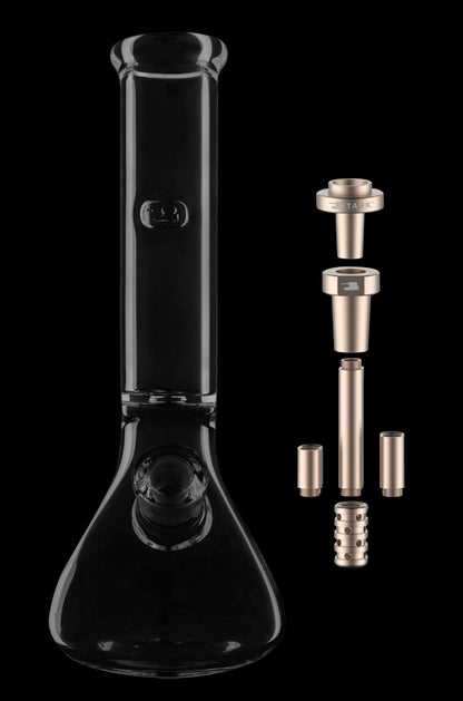 Black glass bong with disassembled gold-toned downstem and accessories on a dark background.