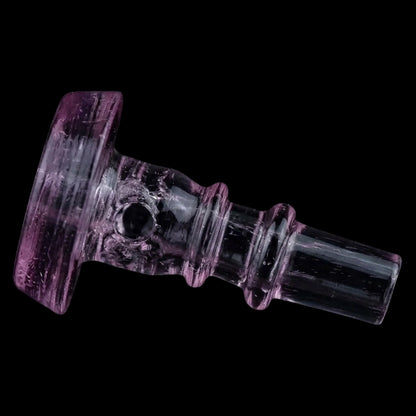 Angled close-up of the Empire Glassworks PuffCo Peak Pro 3D XL Chamber Glass Joystick Cap - Pink Slyme showing its translucent pink glass, rounded ridges, and central air hole against a black background