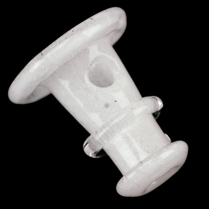 Angled close-up of the Empire Glassworks PuffCo 'New Peak' & Proxy Glass Joystick Cap - Glow in the Dark showing its white, rounded top and hollow side hole against a black background